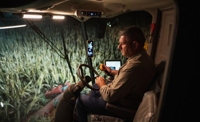 Farmer in a spreader on a maize field