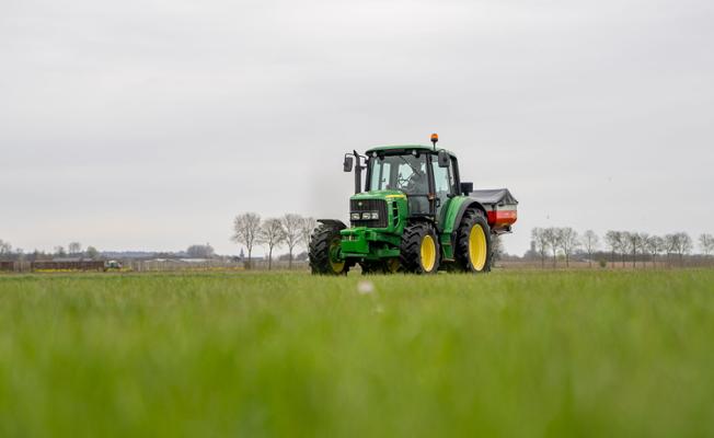 Spreader on a field