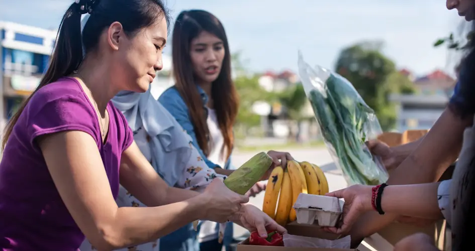 Market seller selling fruit to a customer 