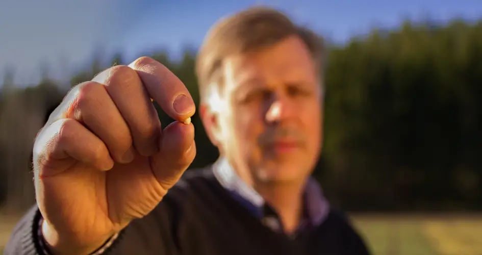 Farmer holding a small pelt of fertiliser