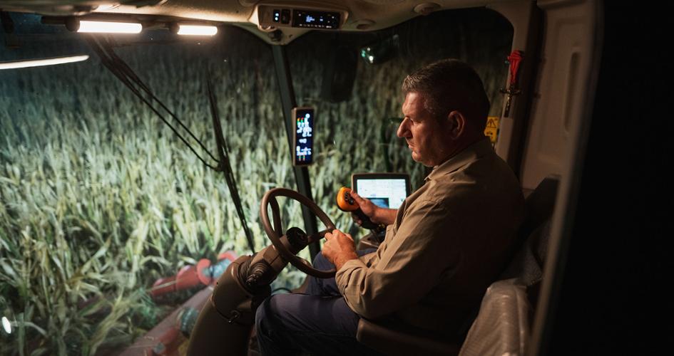 Farmer in a spreader on a maize field